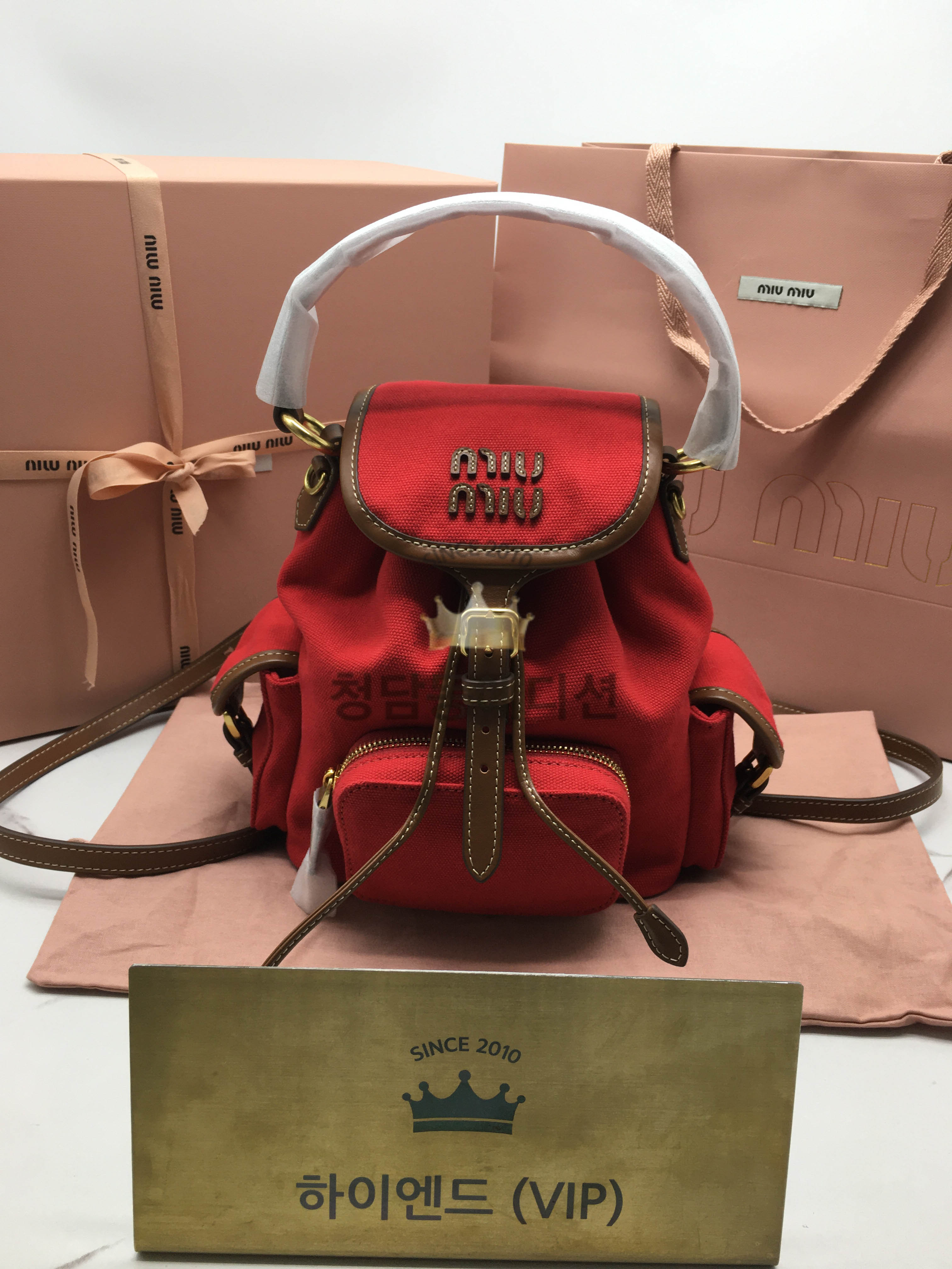 미우미우 엠보싱로고 캔버스 및 가죽 백팩 스몰, 미디움